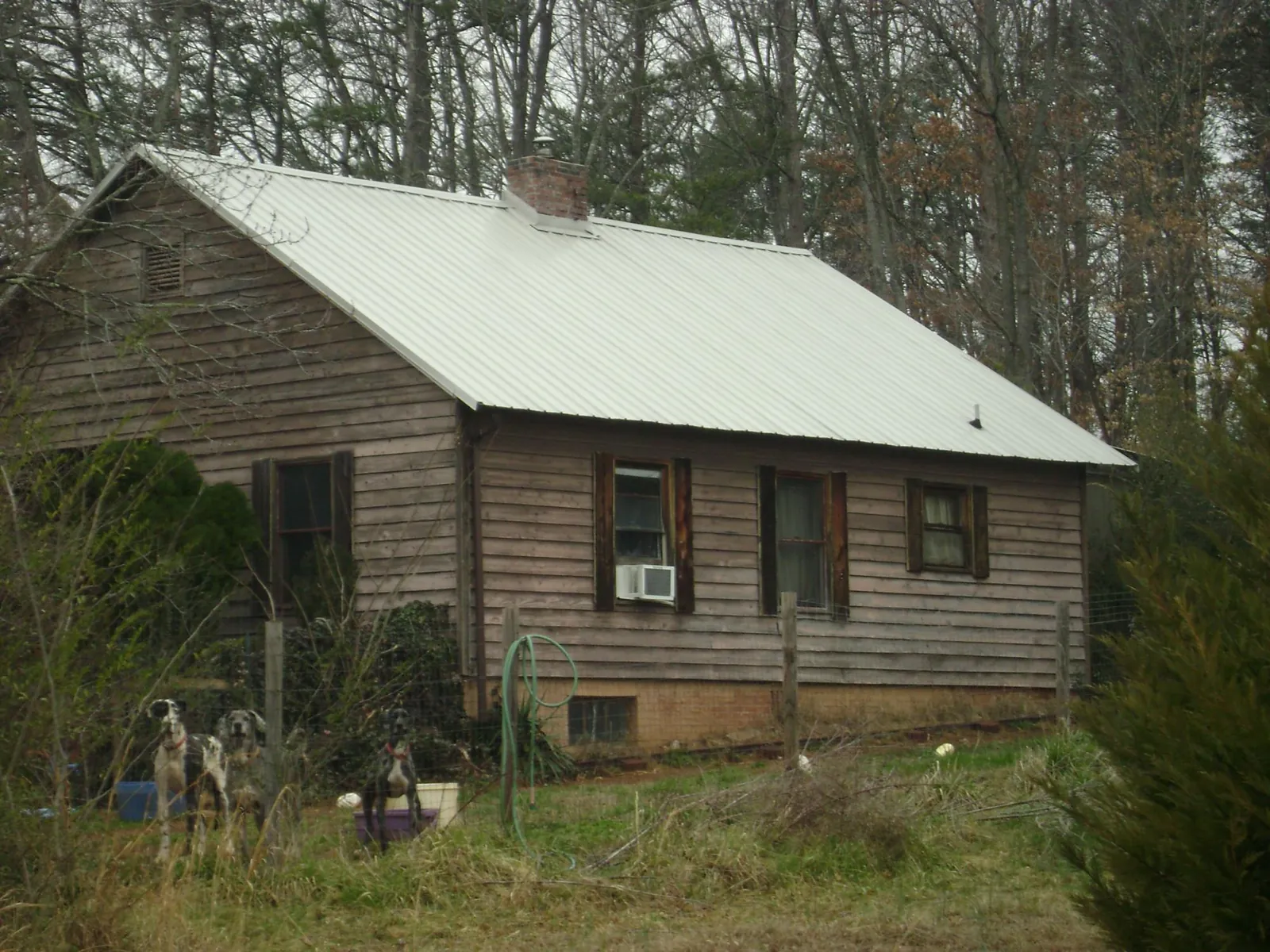 White metal roof on an old wood sided farmhouse, from a Metal Roof Installation job in Holloway